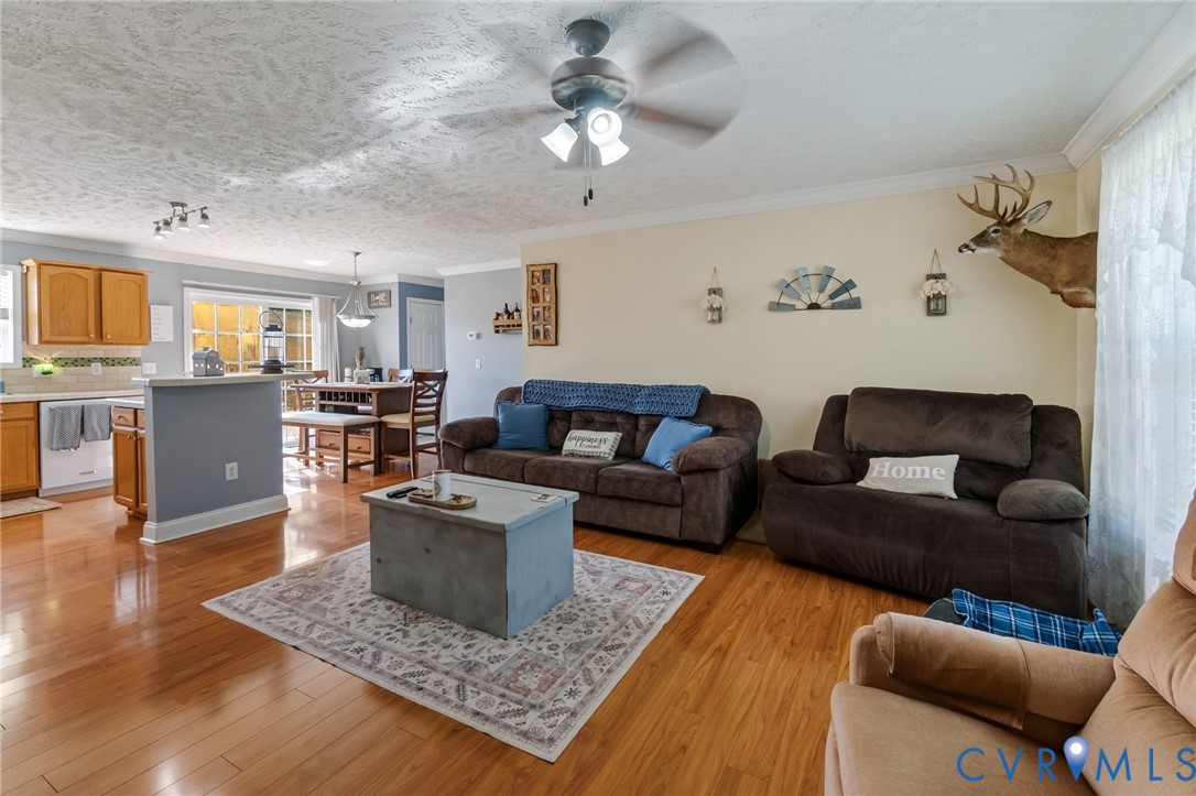 Wood-finish flooring throughout, with a ceiling fa