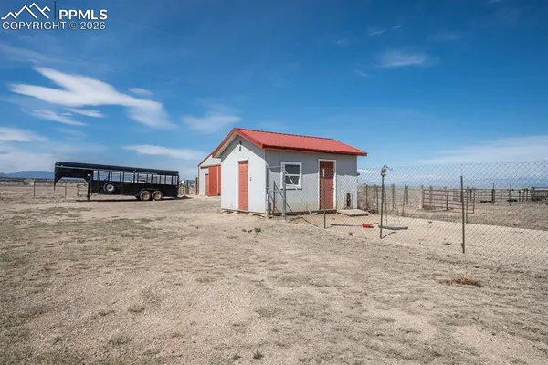a view of a house with backyard and sitting area