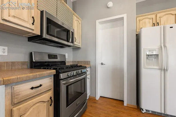 a kitchen with stainless steel appliances a stove a microwave and cabinets
