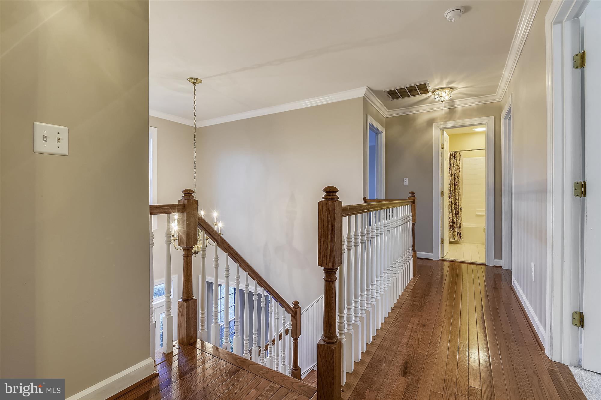 2019 Gresham Lane Davidsonville, MD 21035 - Photo 45 of 85 a view of a hallway with wooden floor and staircase