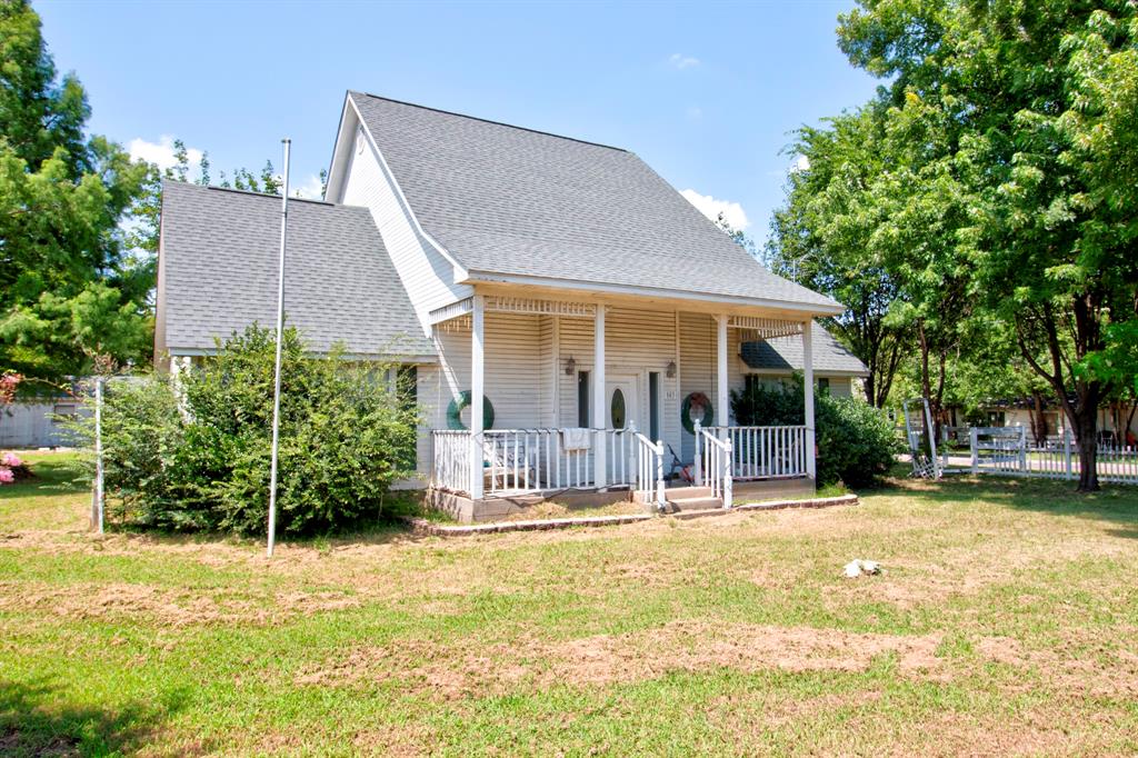 503 Sherman Street Tioga, TX 76271 - Photo 3 of 13 Gable-roof property featuring a covered front porch with white railings and columns