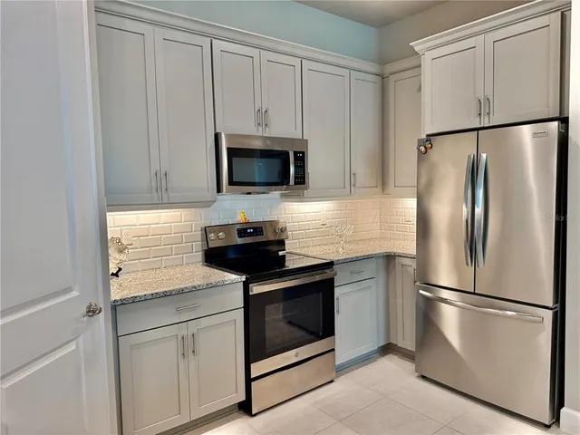 a kitchen with cabinets and chandelier
