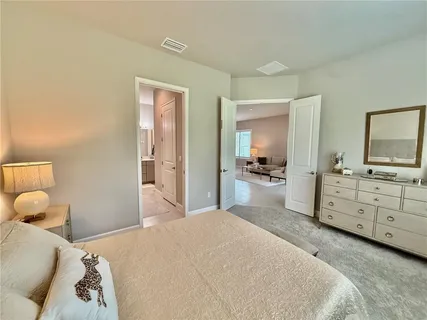 a bedroom with a bed chair and a window