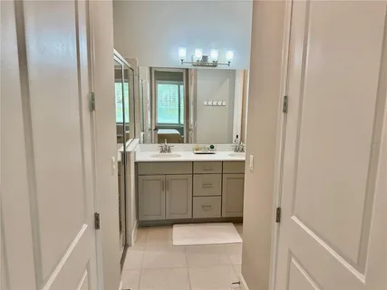 a bathroom with a double vanity sink and a mirror