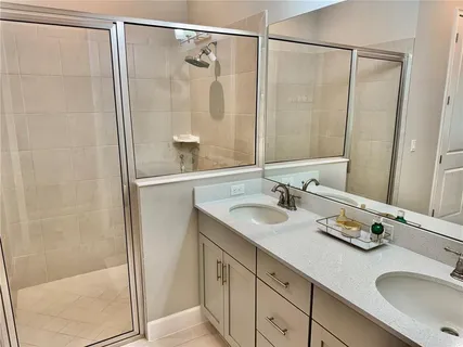 a bathroom with a double vanity sink and a mirror