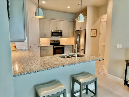 a kitchen with a sink cabinets and window