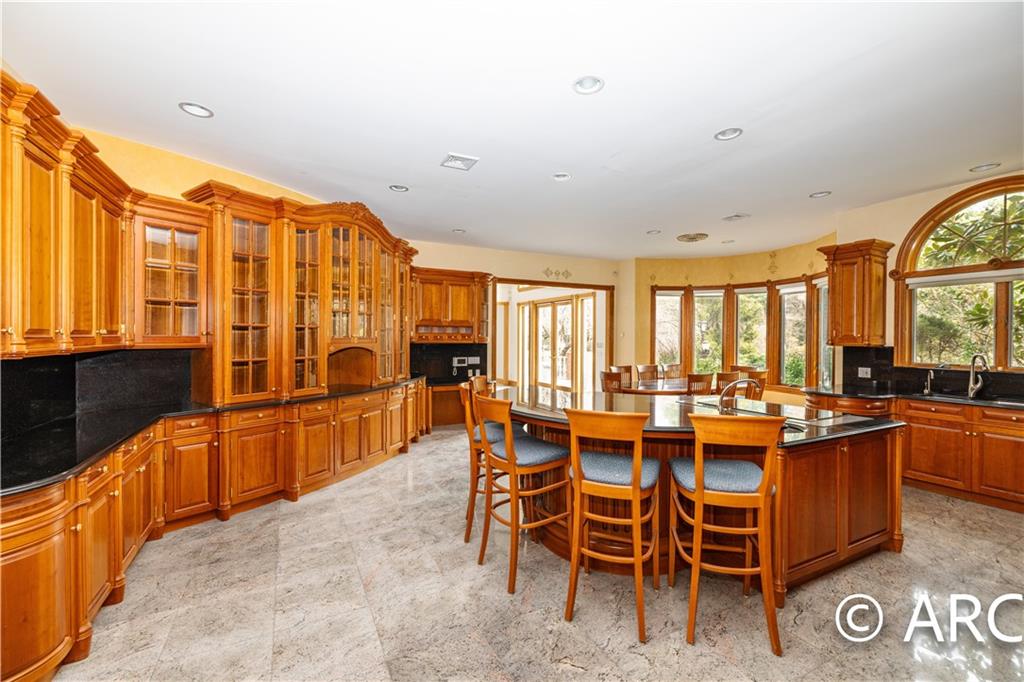 66 Wolver Hollow Road Glen Head, NY 11545 - Photo 11 of 46 a large kitchen with a table and chairs
