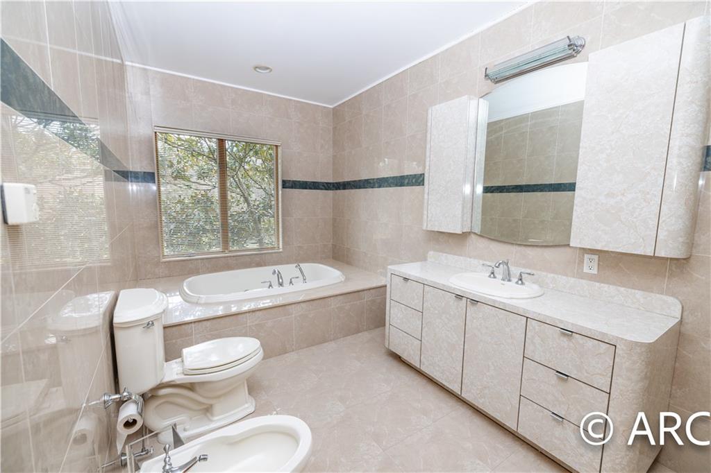 66 Wolver Hollow Road Glen Head, NY 11545 - Photo 29 of 46 a bathroom with a sink toilet bathtub and mirror