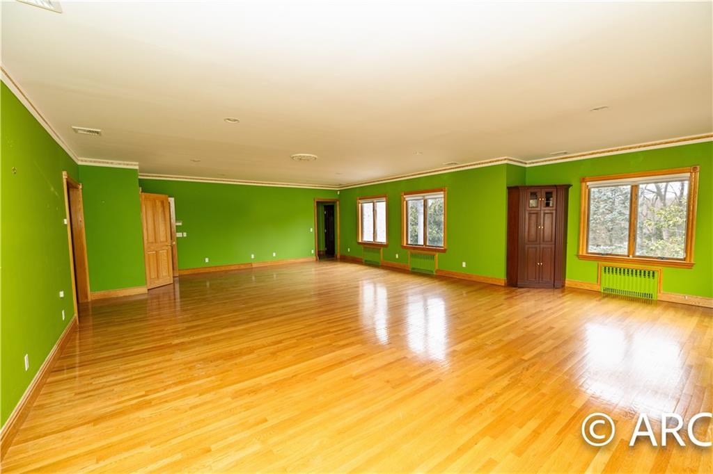 66 Wolver Hollow Road Glen Head, NY 11545 - Photo 33 of 46 a view of empty room with window and wooden floor