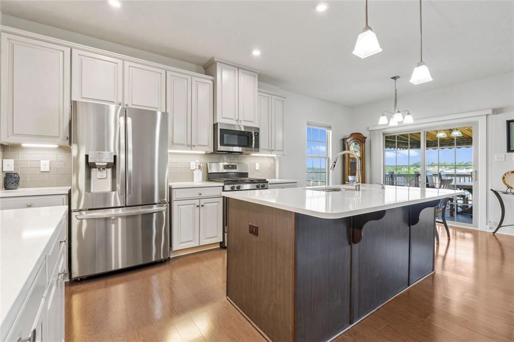 235 Regency Drive Eighty Four, PA 15330 - Photo 11 of 37 a kitchen with stainless steel appliances granite countertop a refrigerator a sink dishwasher a stove and a refrigerator with wooden floor