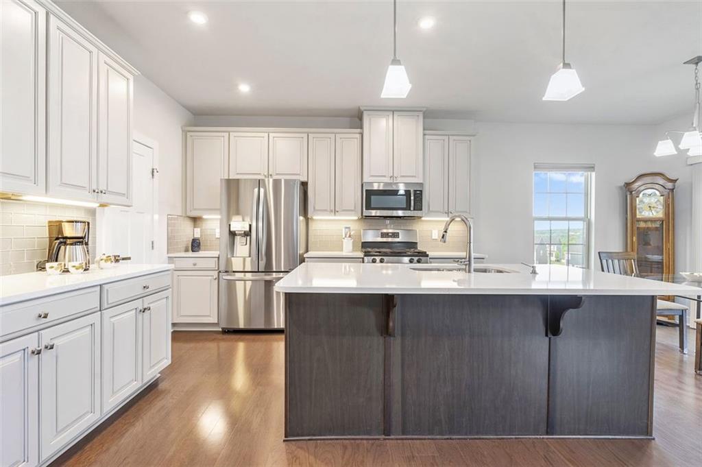 235 Regency Drive Eighty Four, PA 15330 - Photo 12 of 37 a kitchen with stainless steel appliances granite countertop a sink stove and refrigerator