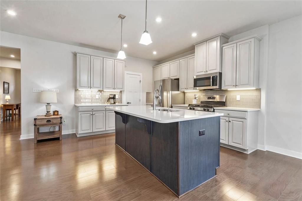 235 Regency Drive Eighty Four, PA 15330 - Photo 15 of 37 a kitchen with kitchen island granite countertop a sink cabinets and wooden floor