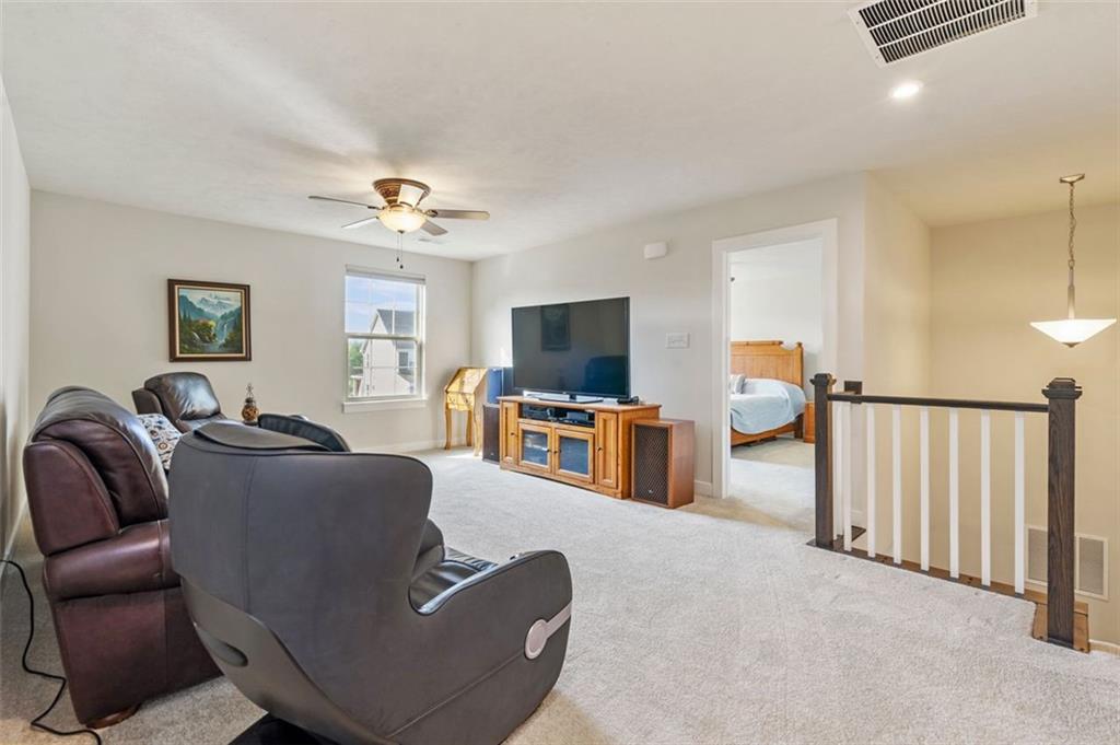 235 Regency Drive Eighty Four, PA 15330 - Photo 26 of 37 a living room with furniture and a flat screen tv