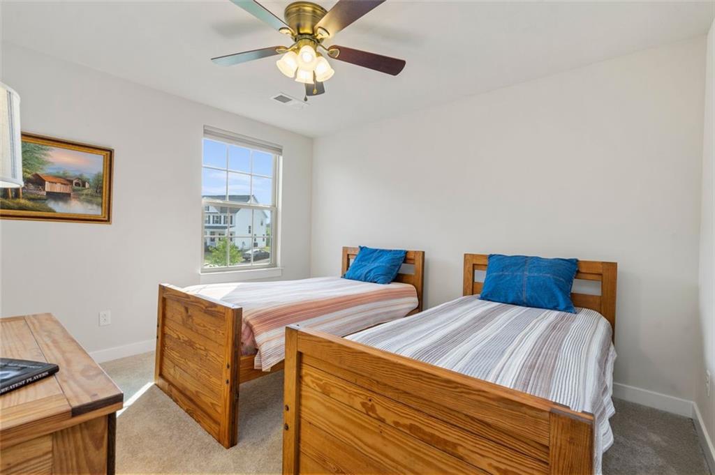 235 Regency Drive Eighty Four, PA 15330 - Photo 30 of 37 a bedroom with two beds and a chandelier