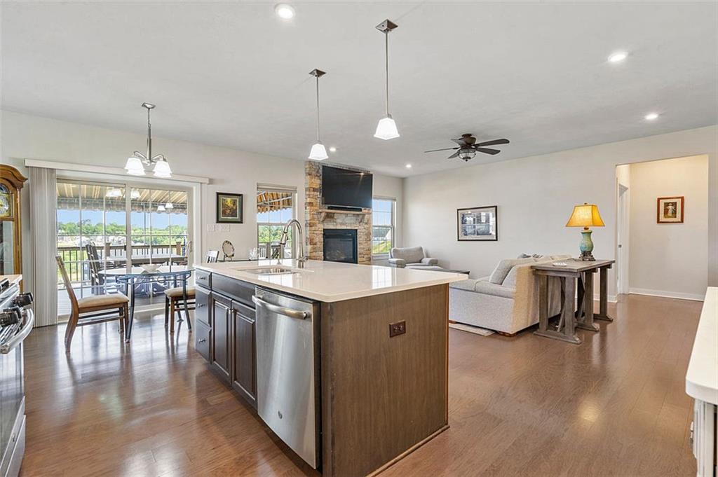235 Regency Drive Eighty Four, PA 15330 - Photo 10 of 37 a kitchen with stainless steel appliances granite countertop a stove a refrigerator a kitchen island a dining table and chairs with wooden floor