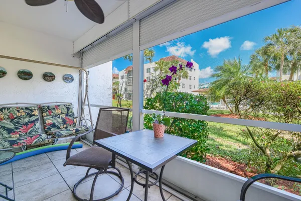 a view of an outdoor dining space with a table and chairs