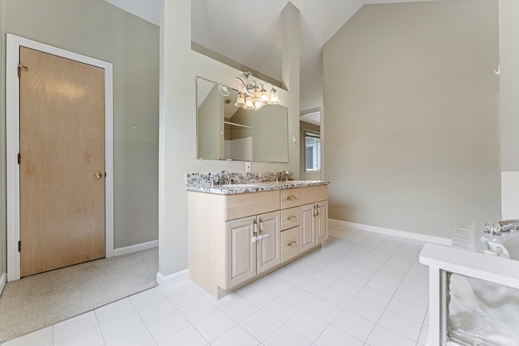 22 Arrowhead Circle, Unit 22 Ashland, MA 01721 - Photo 23 of 35 a bathroom with a double vanity sink and a mirror