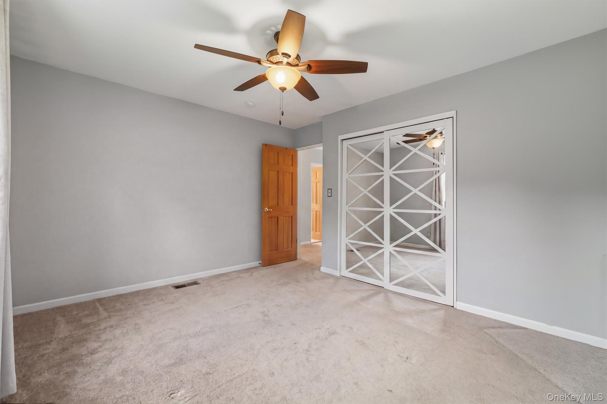 17 Ridge Road Cortlandt Manor, NY 10567 - Photo 17 of 38 Primary Bedroom w/mirrored sliding closet, 2 windows & ceiling fan