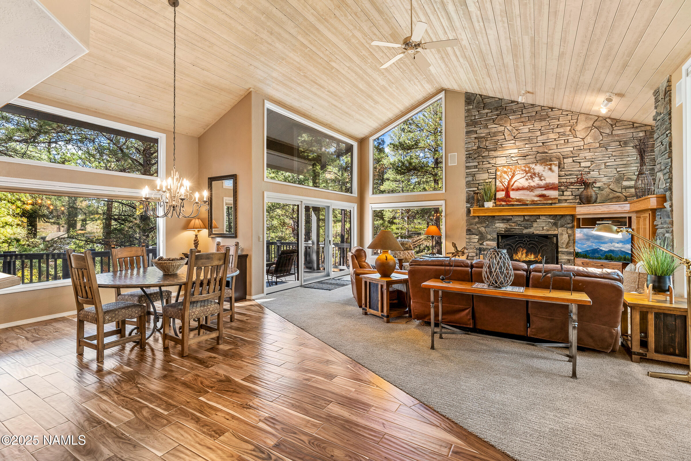 a living room with furniture a large window and a table
