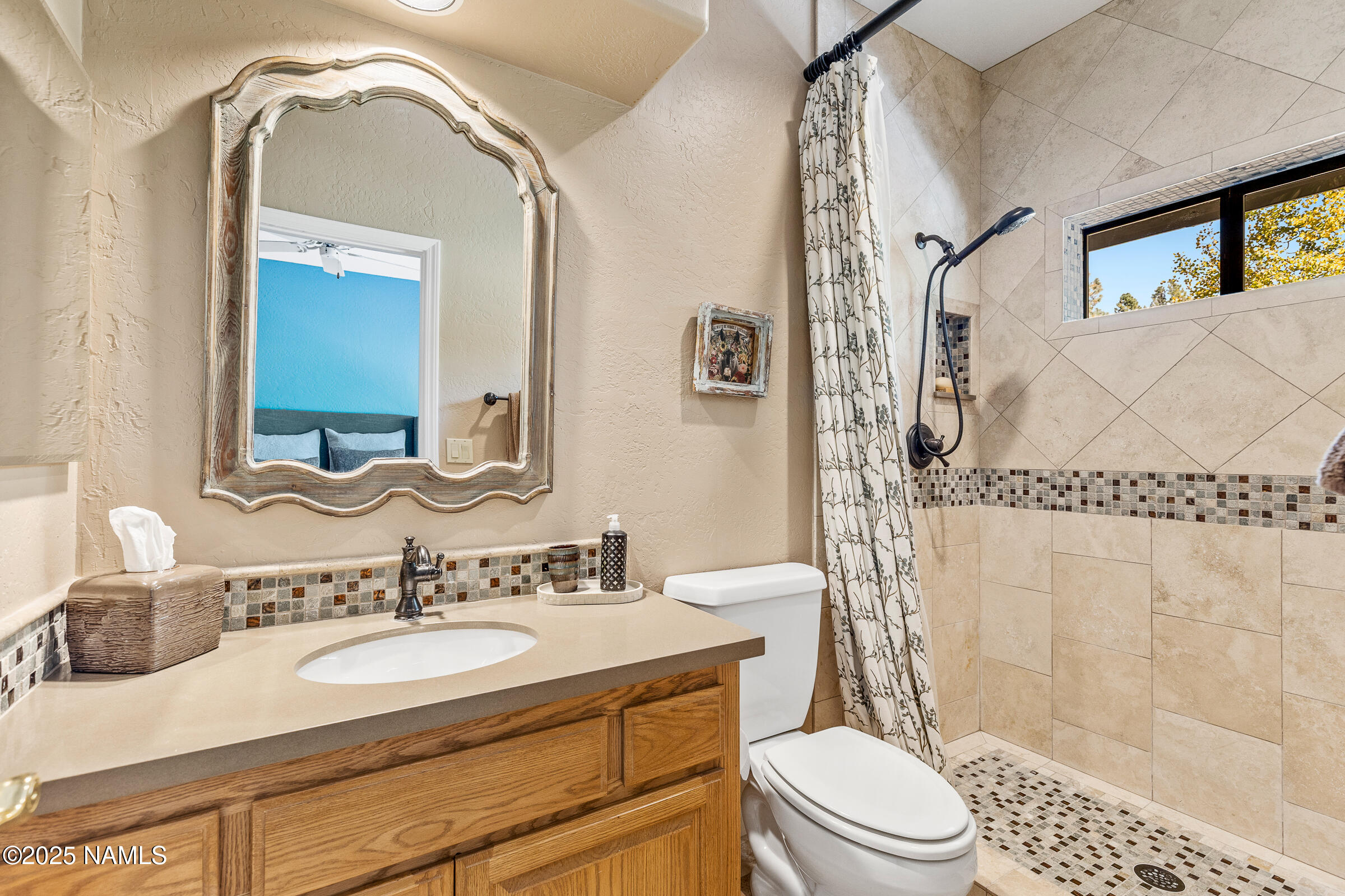 2252 Link Smith Flagstaff, AZ 86005 - Photo 34 of 53 a bathroom with a granite countertop sink toilet a mirror and shower