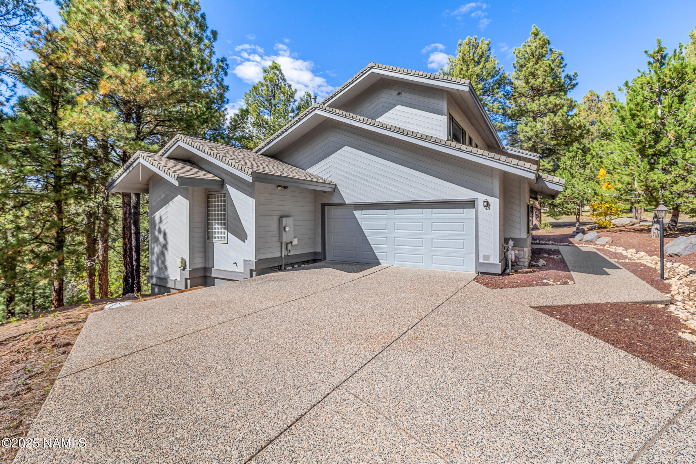 2252 Link Smith Flagstaff, AZ 86005 - Photo 7 of 53 a front view of a house with a yard and garage