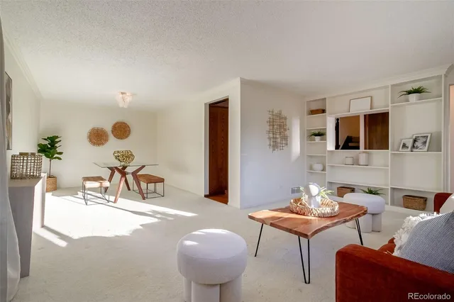 a living room with furniture a rug and a painting on the wall