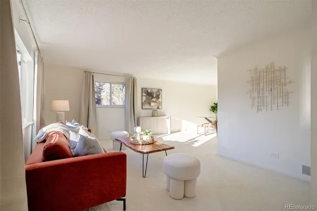 a living room with furniture and a potted plant