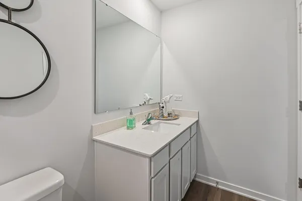 a bathroom with a sink a toilet and a mirror