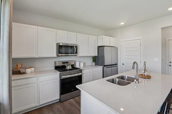 a kitchen with a sink a stove and refrigerator