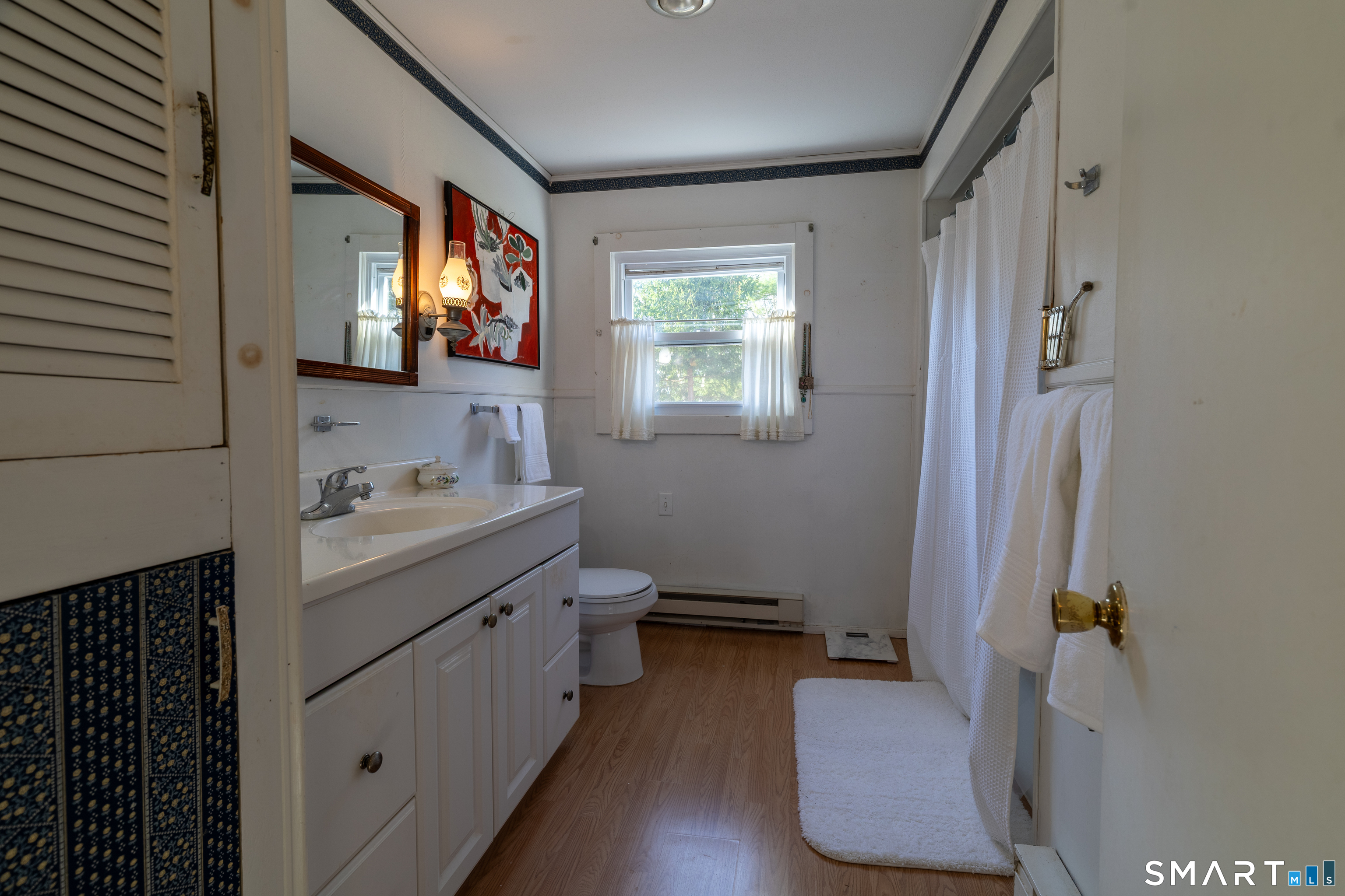 226 Pequot Avenue Groton, CT 06355 - Photo 10 of 11 a bathroom with a sink and a mirror