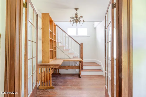 a view of entryway dining room and hall with wooden floor