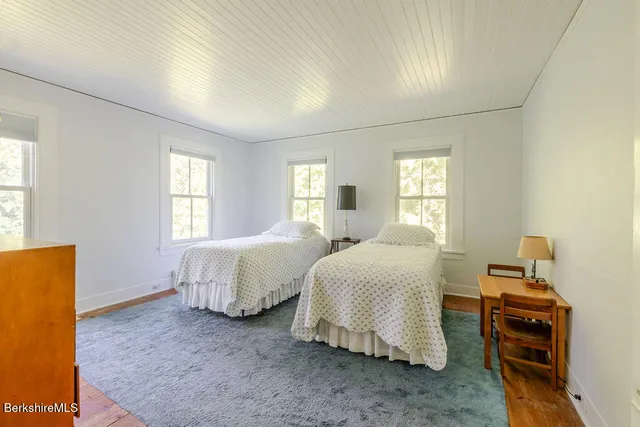 a bedroom with two beds and a couch