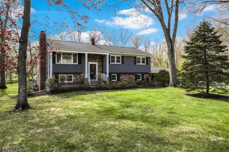 36 Coppergate Drive Bernards, NJ 07920 - Photo 2 of 50 a front view of a house with a yard table and chairs