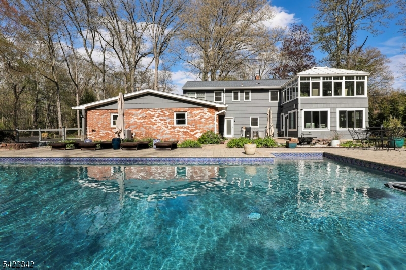 36 Coppergate Drive Bernards, NJ 07920 - Photo 40 of 50 a front view of a house with garden yard and swimming pool