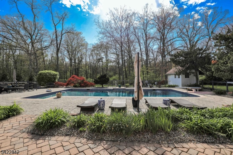 36 Coppergate Drive Bernards, NJ 07920 - Photo 41 of 50 a swimming pool with outdoor seating and plants