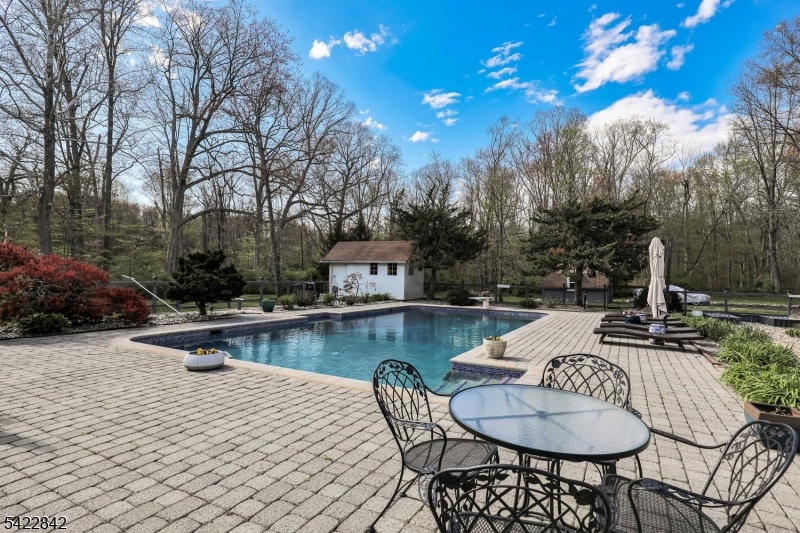 36 Coppergate Drive Bernards, NJ 07920 - Photo 45 of 50 a view of a swimming pool with a patio and fire pit