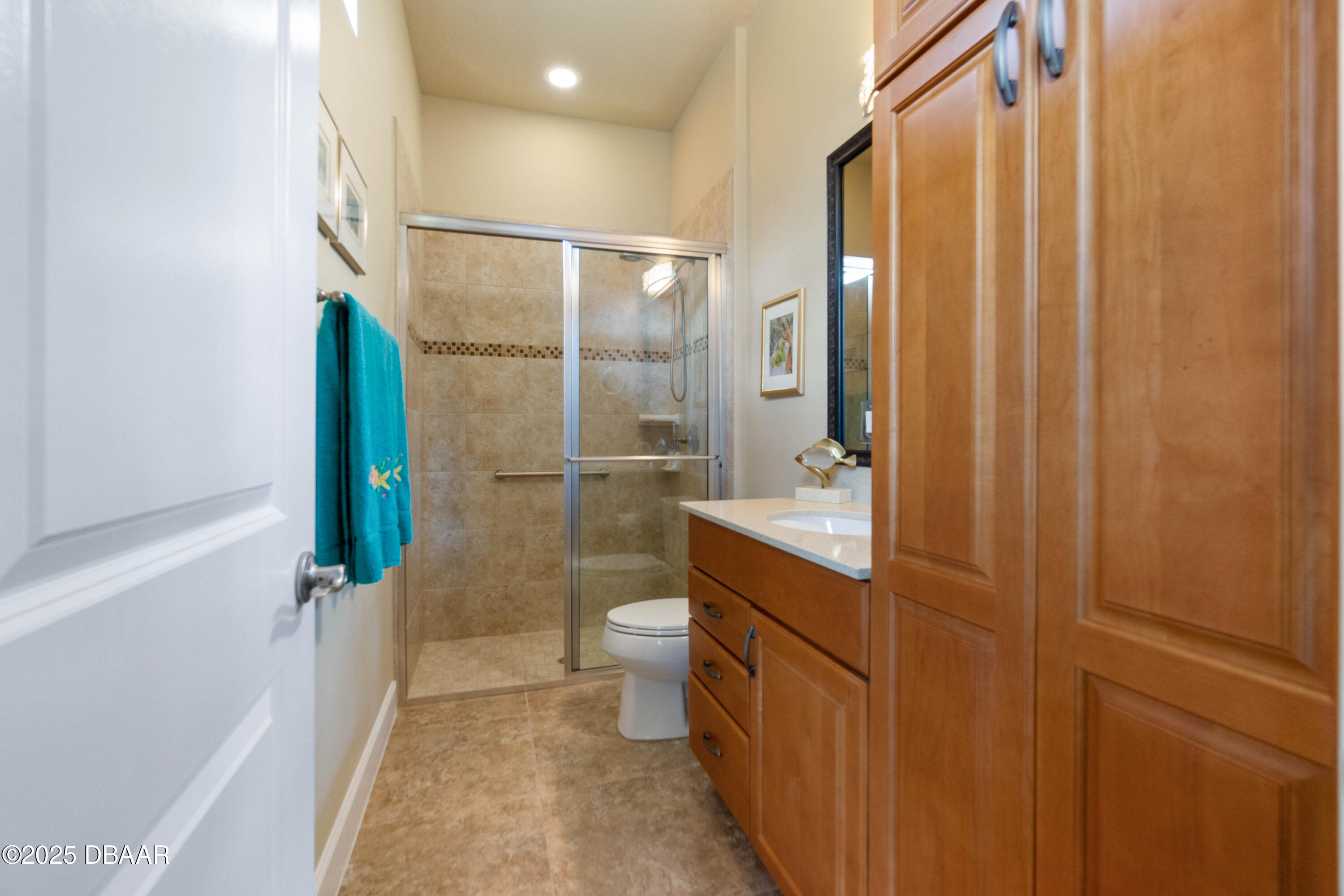990 Downshire Lane Ormond Beach, FL 32174 - Photo 35 of 64 a bathroom with a granite countertop sink a toilet and shower