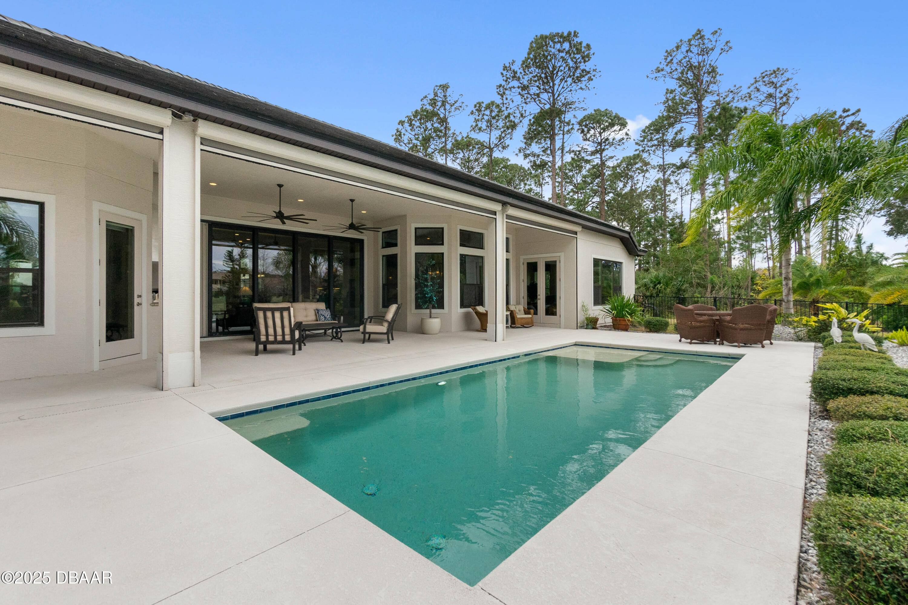 990 Downshire Lane Ormond Beach, FL 32174 - Photo 48 of 64 a view of a house with swimming pool and sitting area