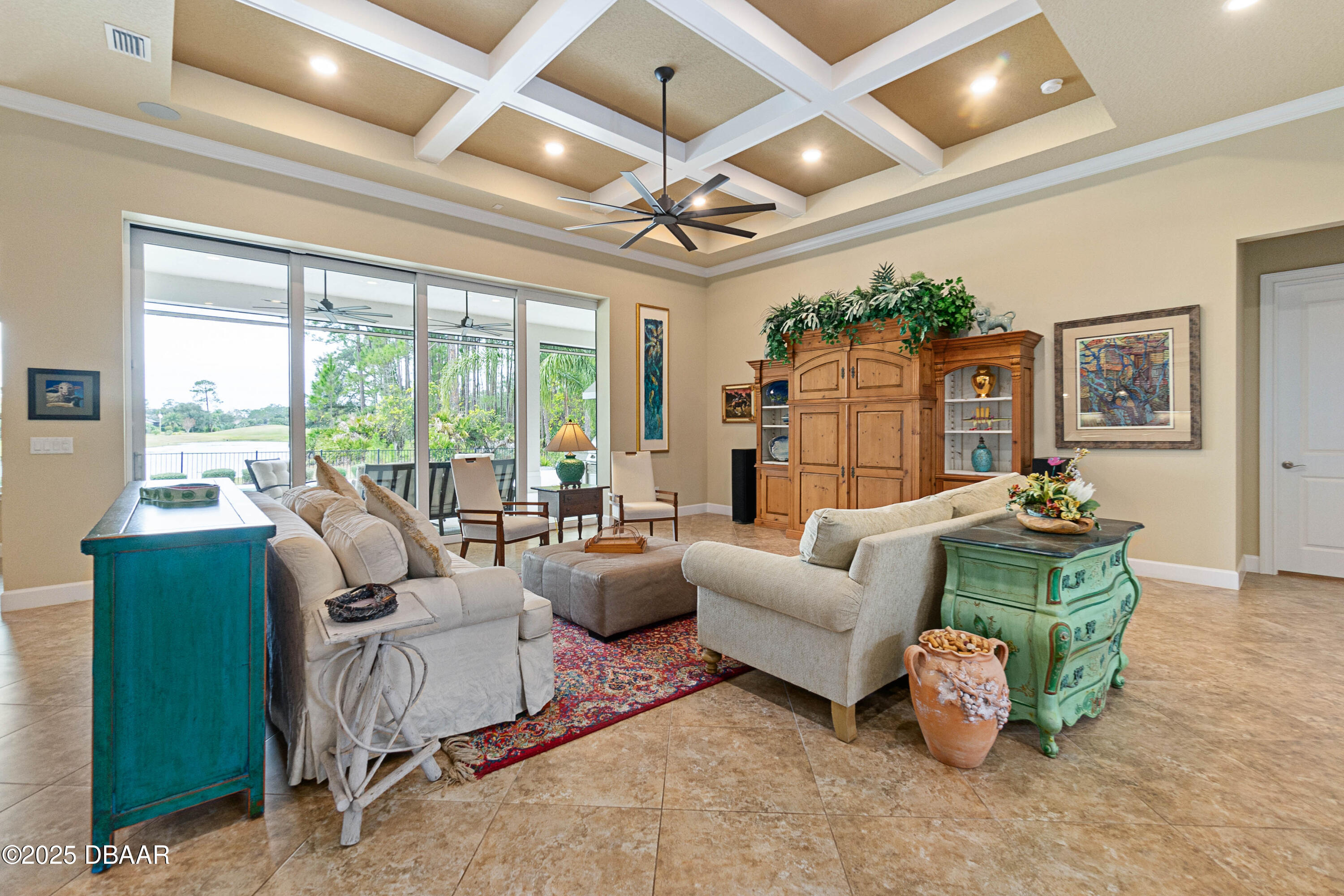 990 Downshire Lane Ormond Beach, FL 32174 - Photo 10 of 64 a living room with furniture ceiling fan and a large window
