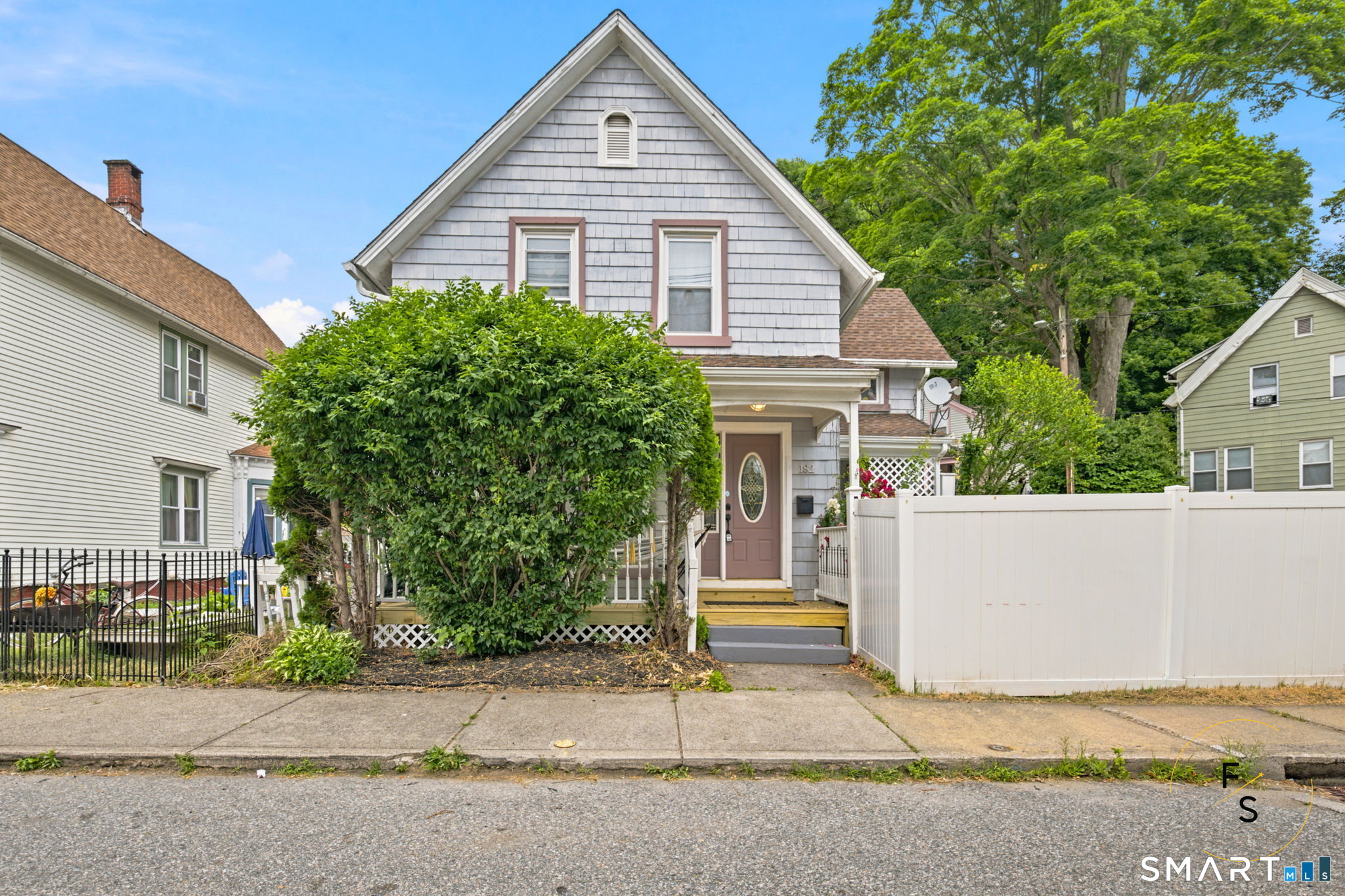 182 Broad Street Norwich, CT 06360 - Photo 1 of 30 a front view of a house with a yard and garage