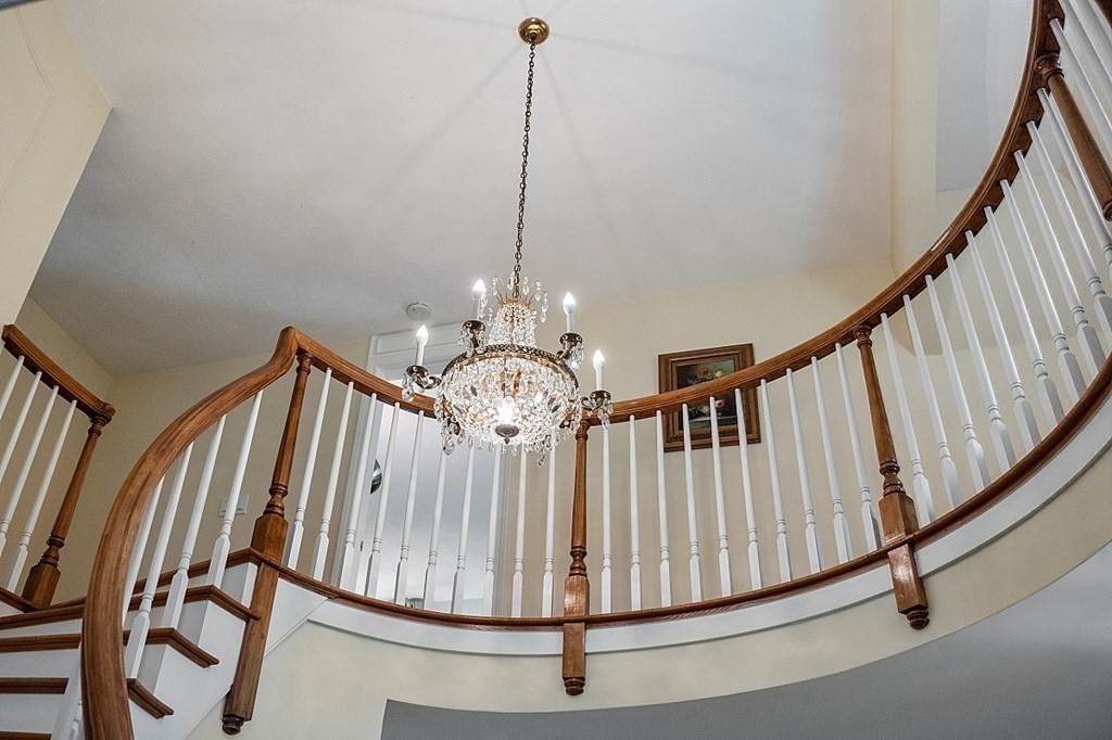 13 Olde Farms Road Boxford, MA 01921 - Photo 11 of 42 a view of staircase with railing and a chandelier