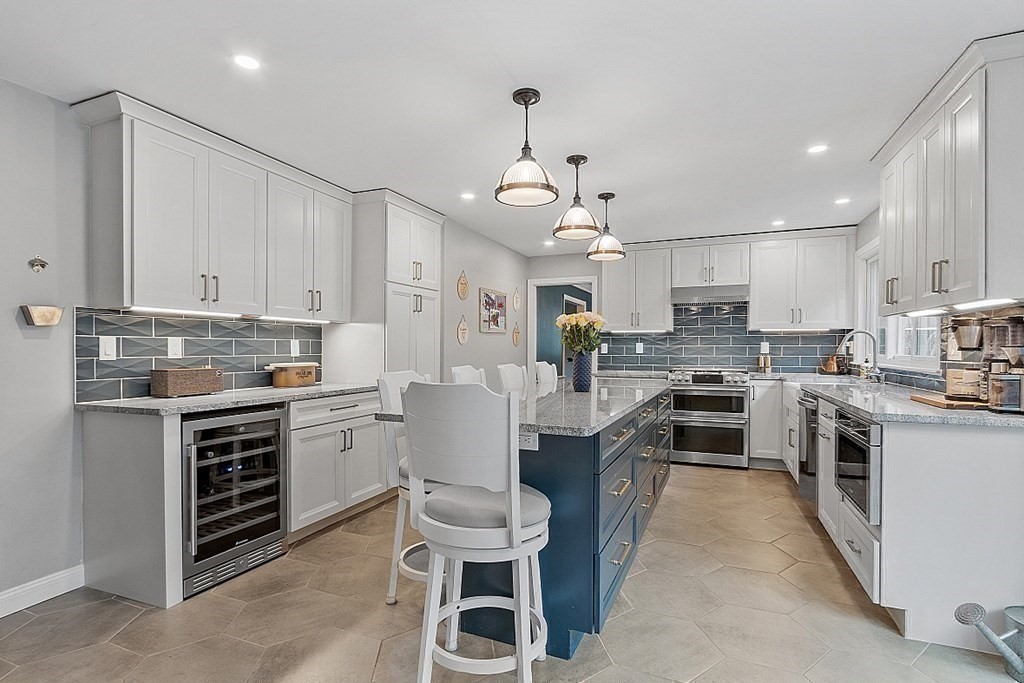 13 Olde Farms Road Boxford, MA 01921 - Photo 17 of 42 a kitchen with white cabinets stainless steel appliances and kitchen island