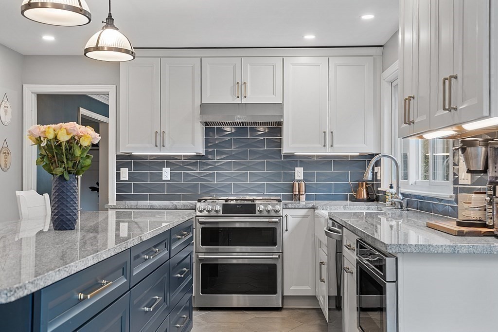 13 Olde Farms Road Boxford, MA 01921 - Photo 18 of 42 a kitchen with stainless steel appliances granite countertop a sink a stove and cabinets