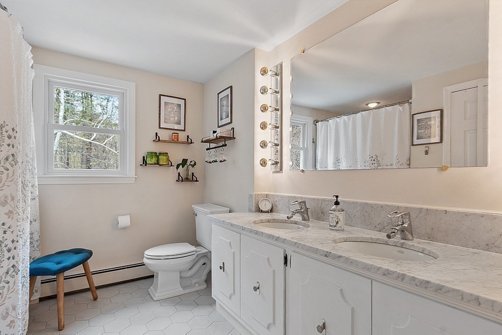13 Olde Farms Road Boxford, MA 01921 - Photo 39 of 42 a bathroom with a granite countertop toilet sink and a mirror