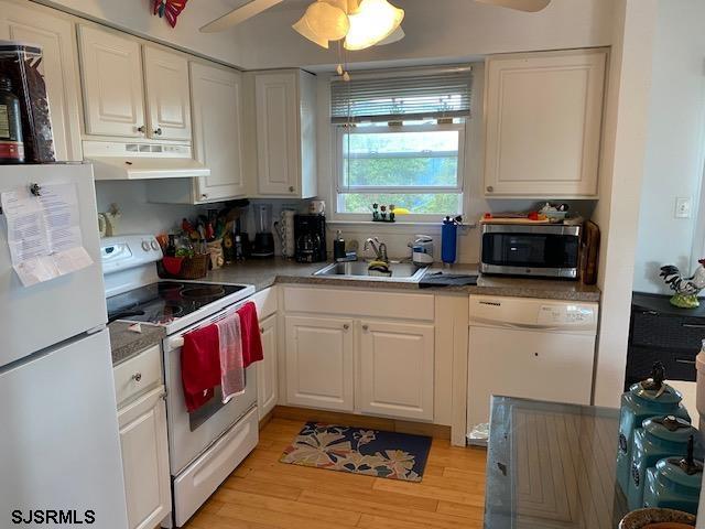 772 Jane Drive Manahawkin, NJ 08050 - Photo 14 of 18 a kitchen with stainless steel appliances granite countertop a stove a sink dishwasher and cabinets with wooden floor