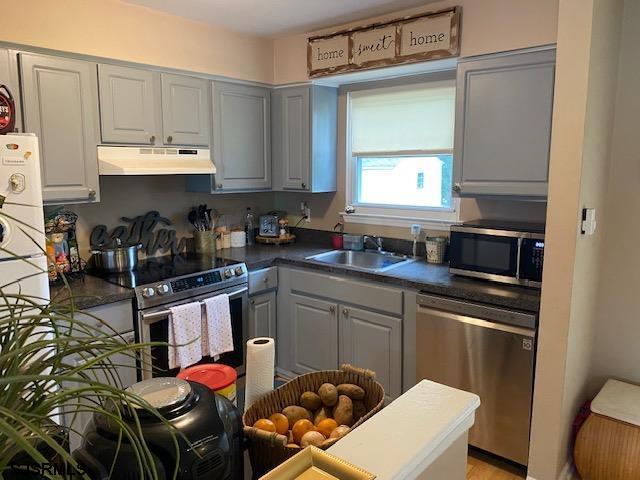 772 Jane Drive Manahawkin, NJ 08050 - Photo 5 of 18 a kitchen with stainless steel appliances granite countertop a stove a sink and a microwave