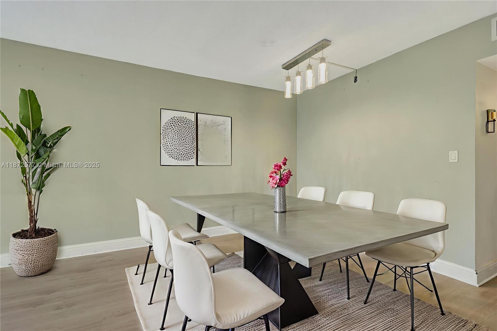 20100 West Country Club Drive, Unit 403 Aventura, FL 33180 - Photo 12 of 24 a view of a dining room with furniture and wooden floor