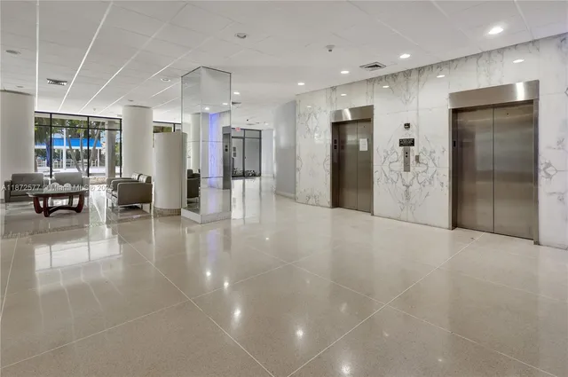 a view of a lobby with furniture and a fireplace