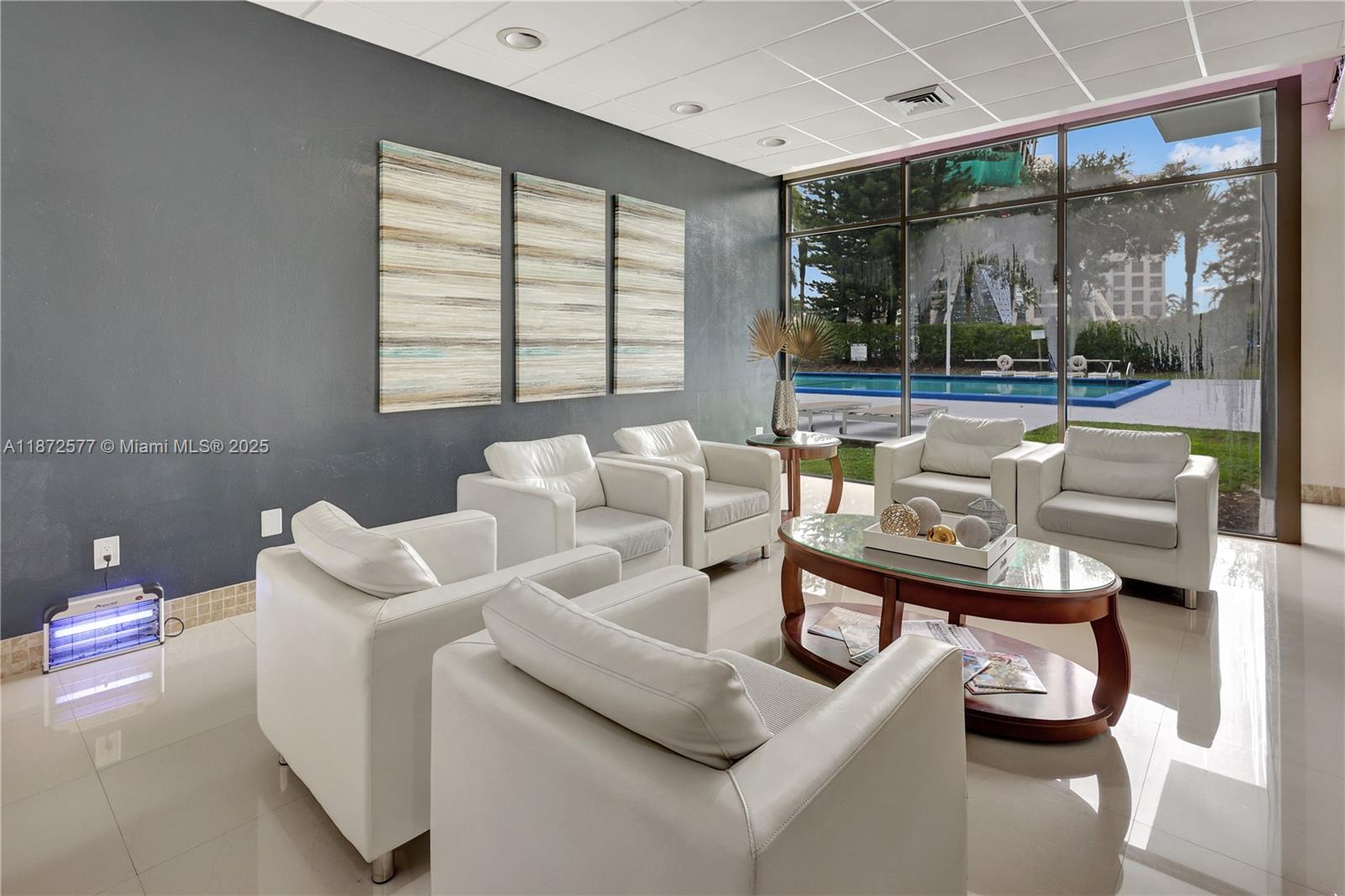 20100 West Country Club Drive, Unit 403 Aventura, FL 33180 - Photo 6 of 24 a living room with furniture and a large window