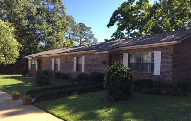 a front view of house with a garden